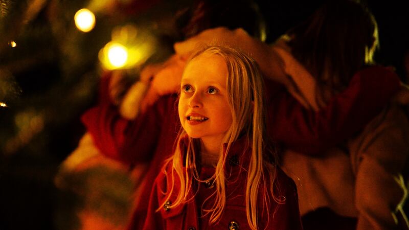 Ali Cotter from Nenagh, Co Tipperary, watching the switching on of the Christmas tree lights by President Michael D Higgins and his wife Sabina at Áras an Uachtaráin on Saturday. Photograph: Cyril Byrne/The Irish Times