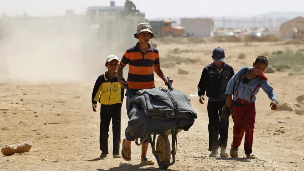 Young Syrian refugees transport supplies received from humanitarian organizations to sell outside of Al-Zaatri refugee camp in the Jordanian city of Mafraq, near the border with Syria. Photograph: Reuters