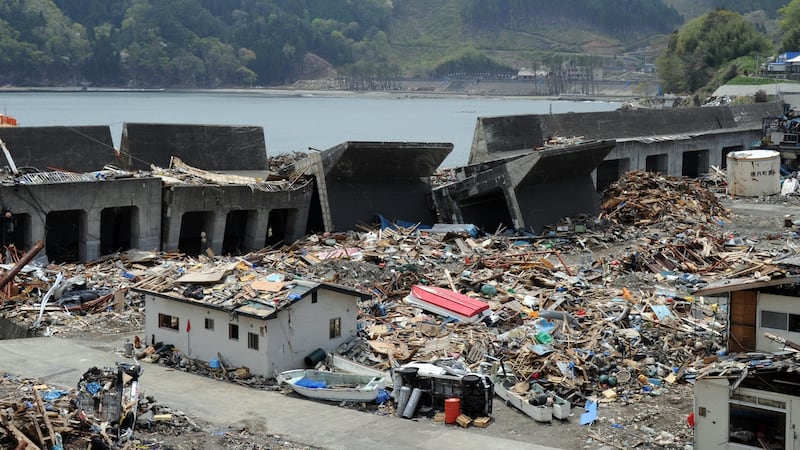 The 12-metre-tall breakwater is seen broken and nearly collapsed by the tsunami in 2011. Photograph: Toshifumi Amura/AFP/Getty Images