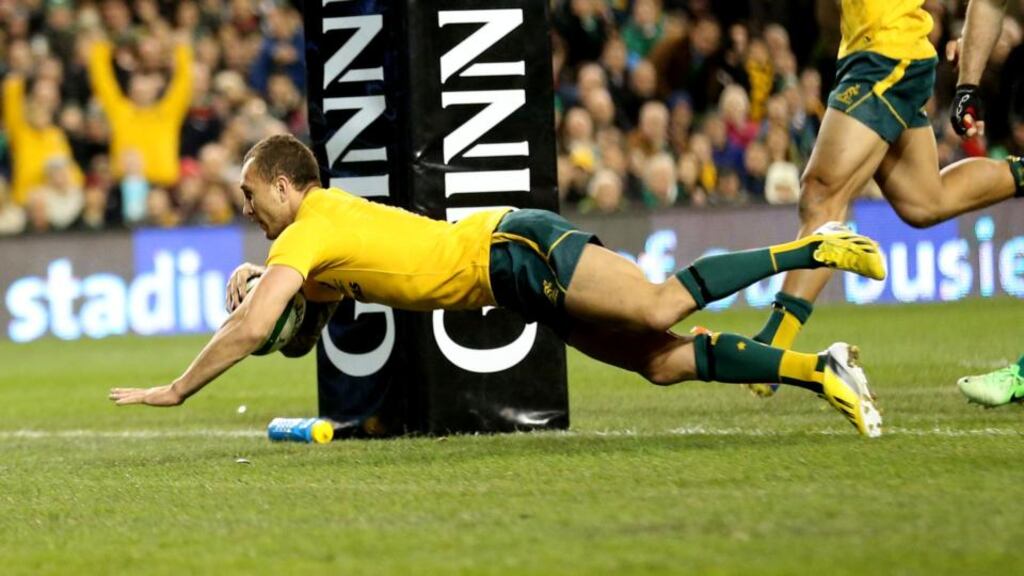 Australia outhalf Quade Cooper scores a try against Ireland during the game at the Aviva Stadium in November. The Wallabies will also take on Ireland at the stadium in November 2014. Photograph: Billy Stickland/Inpho