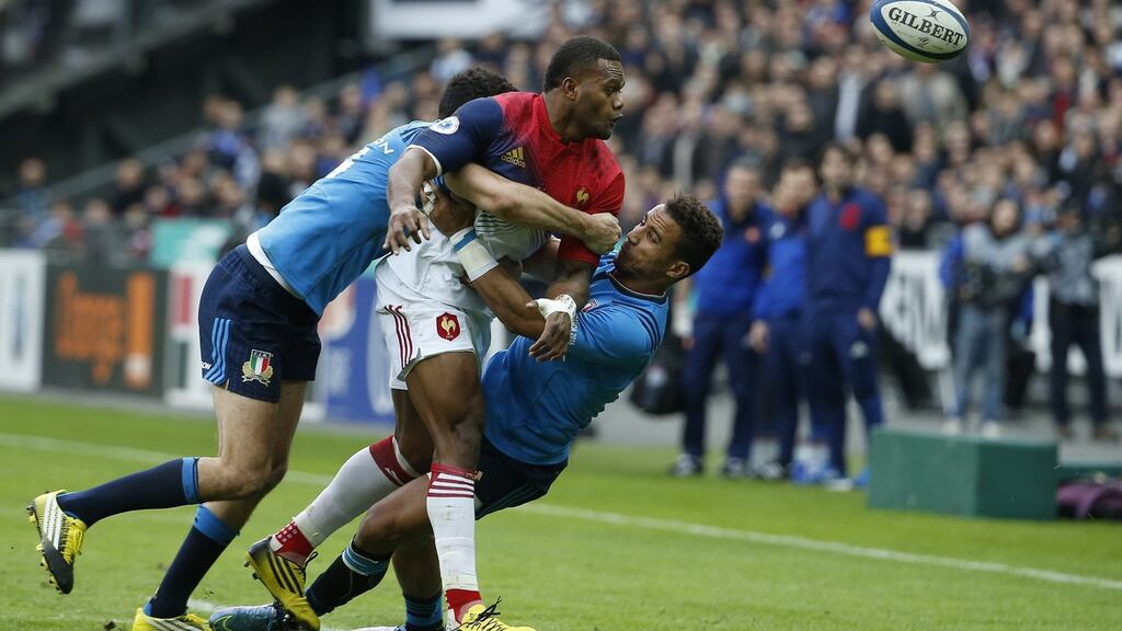 France’s centre Jonathan Danty (C) is tackled during the Six Nations match between France and Italy at the Stade de France in Saint-Denis Photograph: AFP Photo / Thomas Samson