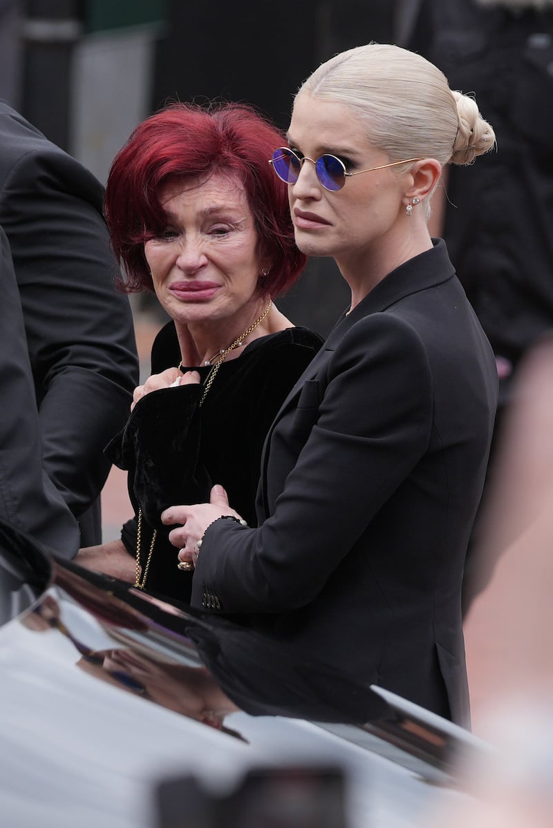 Sharon Osbourne and Kelly Osbourne stop to view tributes to the late Ozzy Osbourne from fans. Photograph: Christopher Furlong/Getty Images