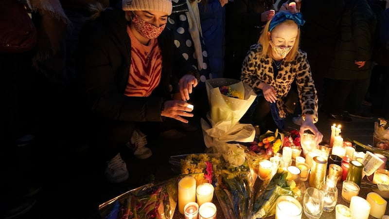 People leave candles and flowers at a make-shift shrine during a vigil at Leinster House, Dublin. Photograph: Brian Lawless/PA Wire