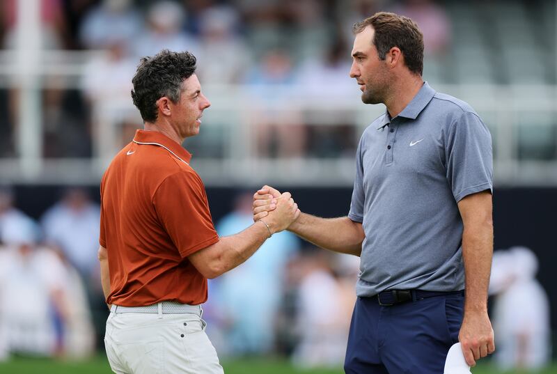 Rory McIlroy shakes hands with Scottie Scheffler after finishing the second round of the PGA Championship. Photograph: Alex Slitz/Getty Images