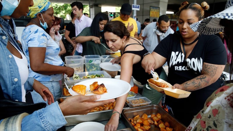 Food is served on Thursday from an outdoor kitchen set up for those made homeless by the massive fire in Grenfell Tower in London. Photograph: Alastair Grant/AP