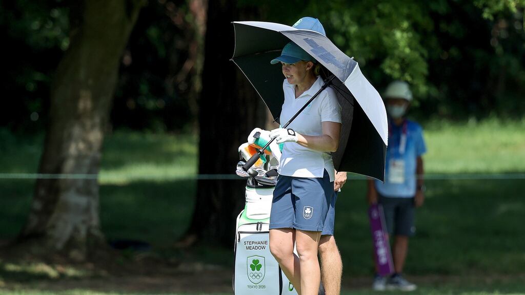 Ireland’s Stephanie Meadow takes shade under an umbrella during the third round of the women’s individual stroke play golf. Photograph: Bryan Keane/Inpho