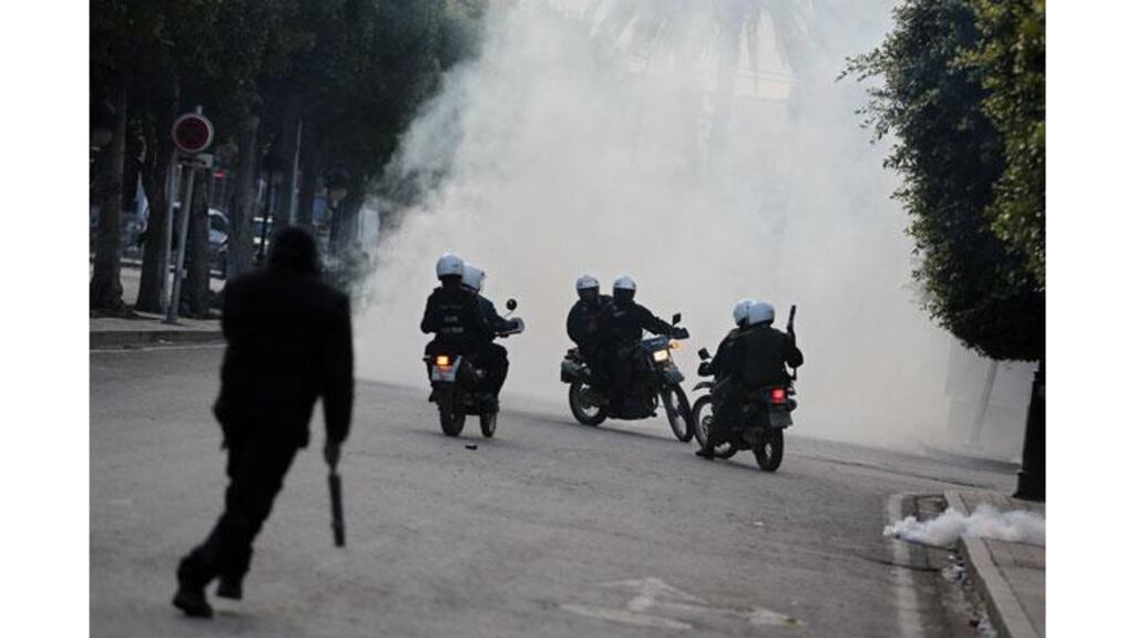 Riot police on motorcycles ride through tear gas during clashes with protesters in Tunis yesterday. Photograph: Tara Todras-Whitewhill/The New York Times