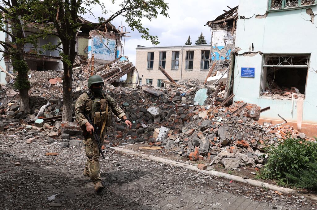 A Ukrainian serviceman passes by destroyed buildings in the Ukrainian town of Siversk, Donetsk region. Photograph: Anatolii Stepanov/AFP/Getty Images