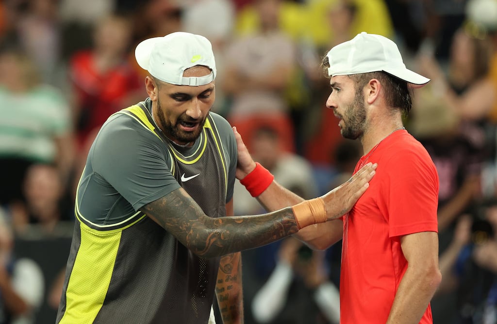 Nick Kyrgios of Australia is consoled by Jacob Fearnley of Great Britain following Fearnley's first-round victory in the Australian Open. Photograph: Kelly Defina/Getty Images
