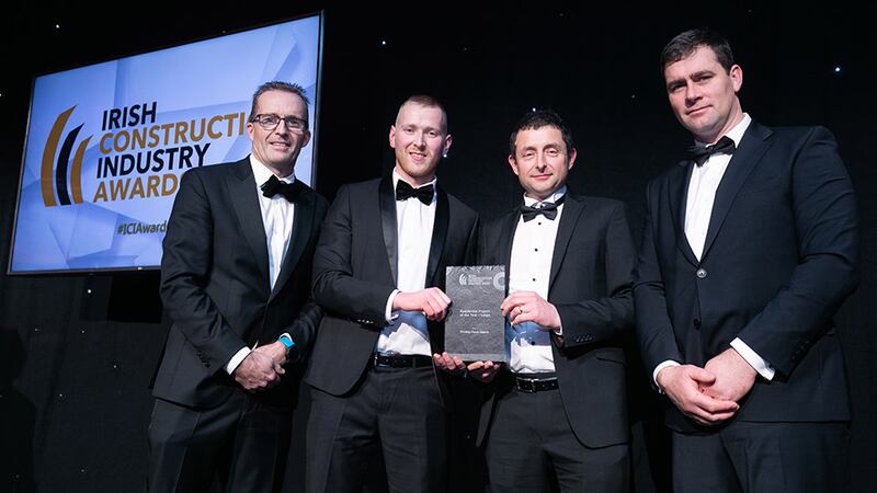 Neil Wall, head of Entries, BusinessRiver, presents the Residential Project of the Year – Large award the Bennett (Construction) team.