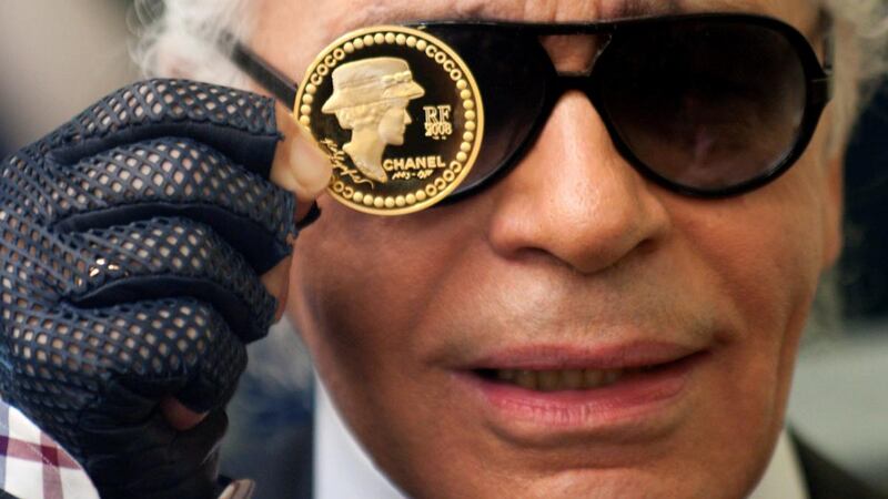 Karl Lagerfeld presents a €5 coin, designed by him in 2008, to commemorate the 125th anniversary of birth of  Gabrielle “Coco” Chanel. Photograph: Reuters/Philippe Wojazer/File Photo