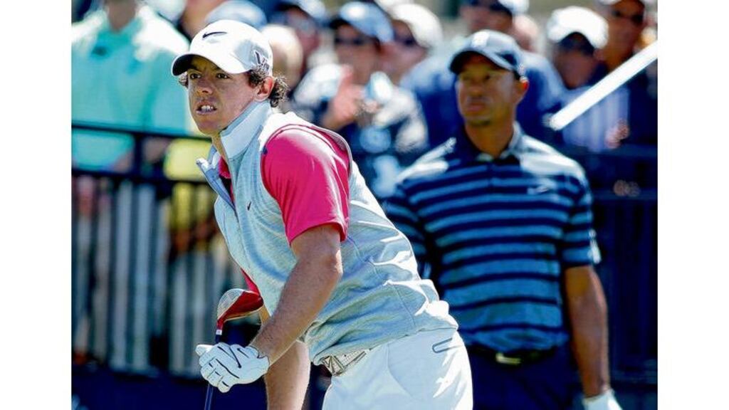 Rory McIlroy watches a tee shot anxiously as Tiger Woods looks on during the opening round of the WGC-Cadillac Championship at Doral yesterday. photograph: scott halleran/getty images