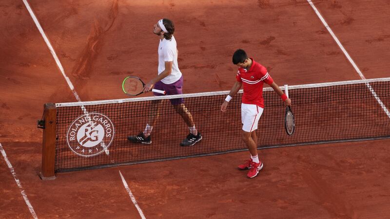 Stefanos Tsitsipas and Nivak Djokovic meet at the net folliwing the French open final. Photograph: Adam Pretty/Getty