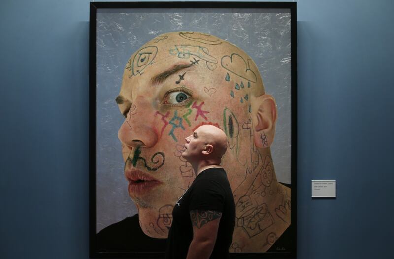 Gordon Harris beside his portrait entitled Kids at the National Gallery of Ireland as part of the Hennessy Portrait Prize. Photograph: Leon Farrell/Photocall Ireland.
