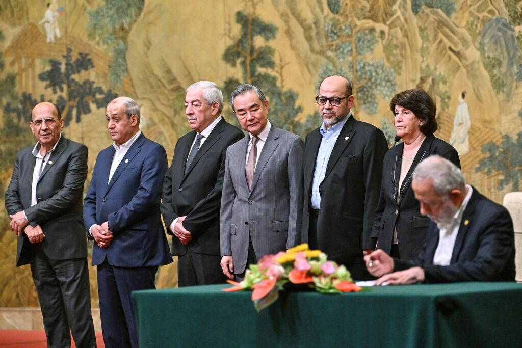 China's foreign minister Wang Yi (centre) and others at the signing in Beijing: The signatories will press for an end to 'the brutal siege’ of Gaza and the West Bank, and delivery of ‘humanitarian and medical aid without restrictions’. Photograph: Pedro Pardo/AFP