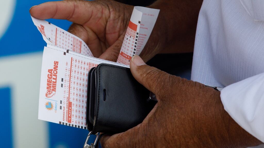 A customer buying a Mega Millions lottickets earlier this week. Photograph: Eugene Garcia/EPA