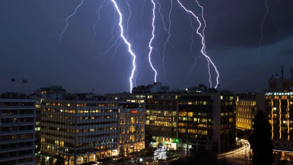 Lightning strikes over buildings at central Syntagma square during heavy rainfall in Athens on Monday. Photograph: Marko Djurica/Reuters