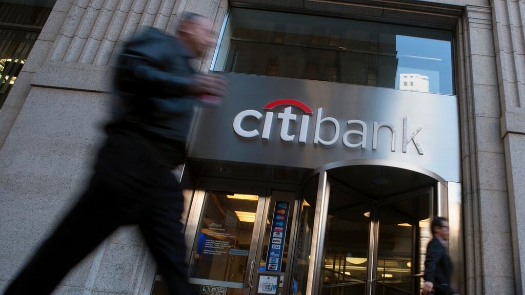 Passersby walk in front of a Citibank branch in New York. A Manhattan federal judge has signaled he will not rubber-stamp Citigroup's proposed $590 million settlement of a shareholder lawsuit accusing it of hiding tens of billions of dollars of toxic mortgage assets.
Photograph: Keith Bedford/Reuters.