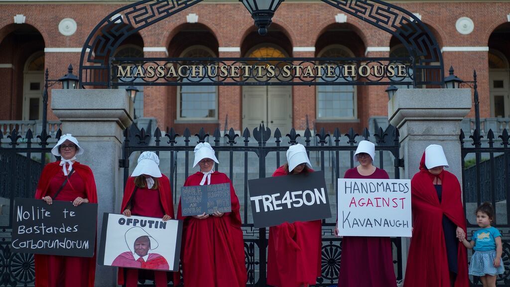 Women dressed in Handmaids cloaks and hoods, hold signs in protest of United States President Donald J. Trump while standing in front of the Massachusetts State House in Boston, Massachusetts. Some 35 per cent of rich young Americans believed that it would be a ‘good’ thing for the army to take over EPA/CJ GUNTHER