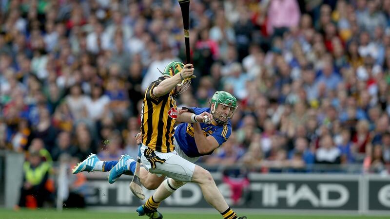 Richie Power of Kilkenny with James Barry of Tipp during the 2014 game. Photo: Donall Farmer/Inpho