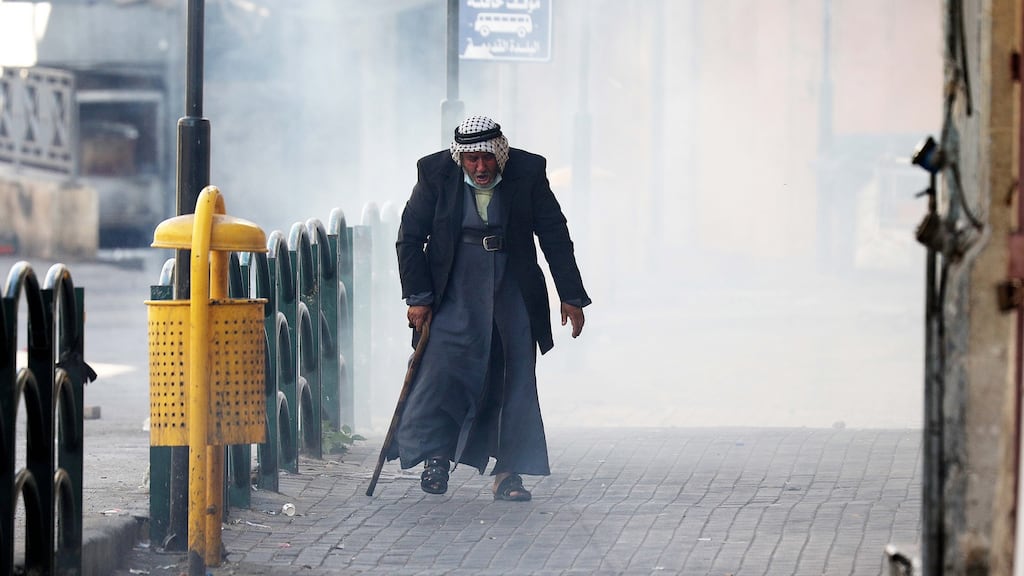An elderly Palestinian man during clashes in the West Bank city of Hebron. Photograph: Abed al Hashlamoun/EPA