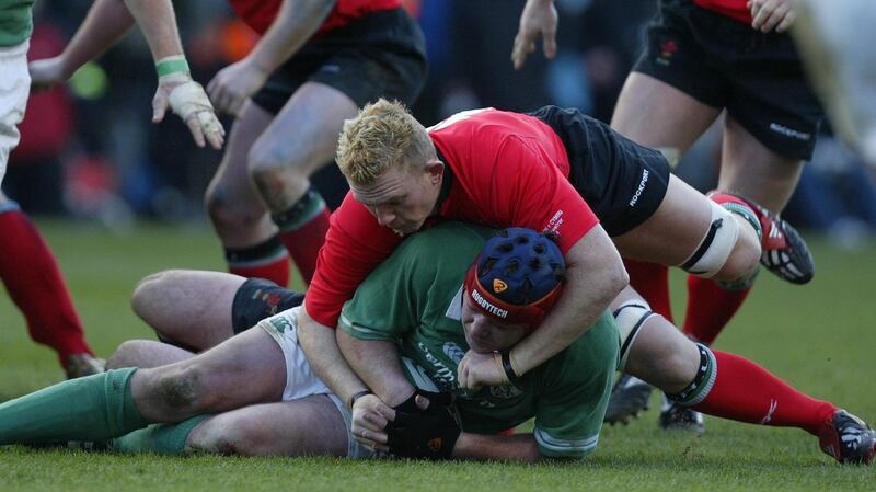 Alex Popham tackles Anthony Foley during a Six Nations match in 2004. Photograph: Billy Stickland/Inpho