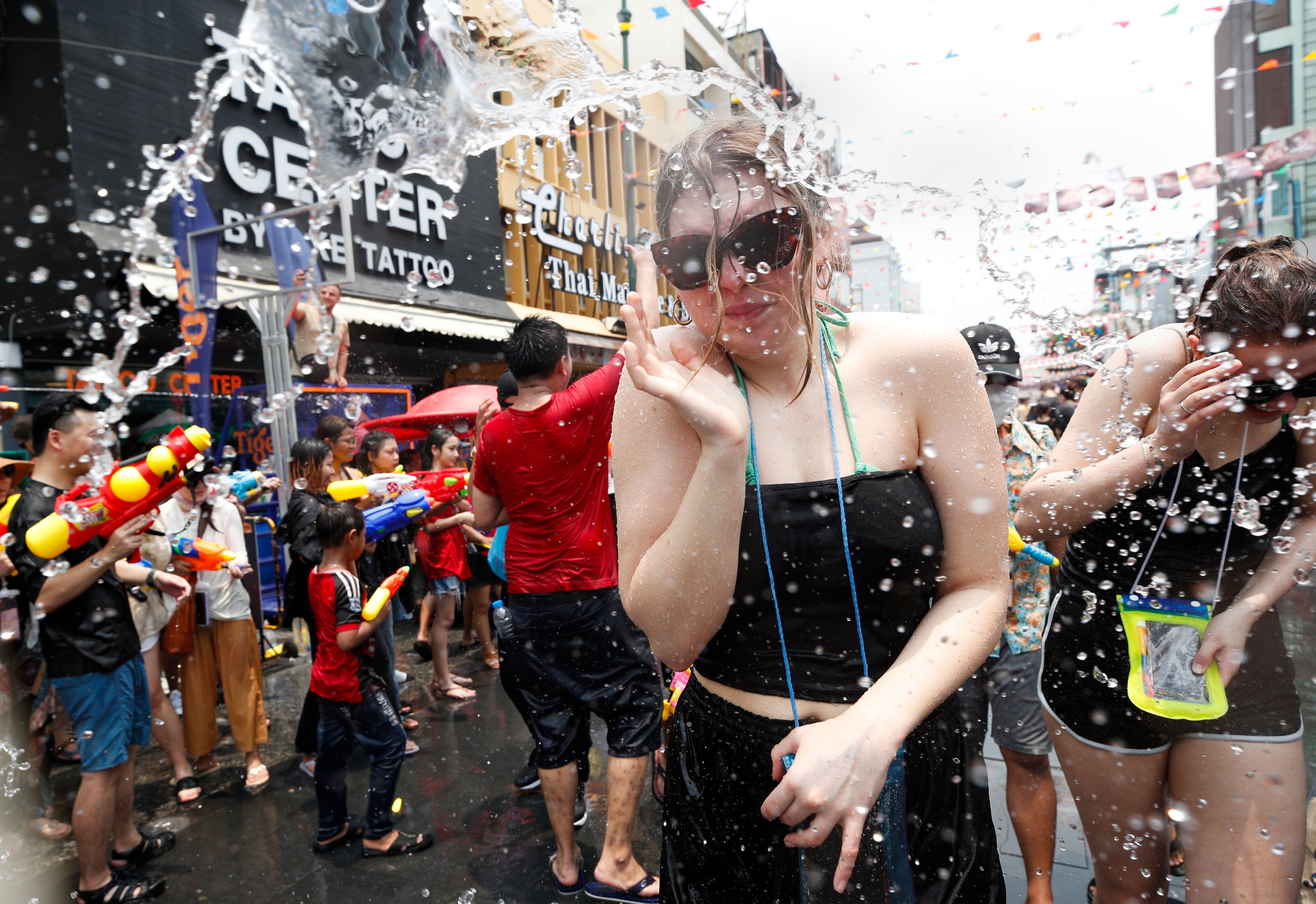 A tourist during a water gun battle as part of the annual Songkran festival, also known as water festival, the traditional Thai new year celebrations, at the tourist spot of Khao San Road in Bangkok, Thailand. Photograph: Rungroj Yongrit/EPA