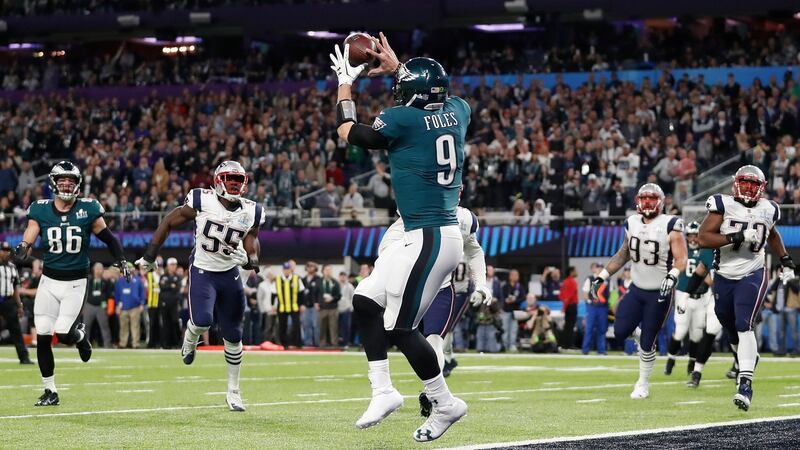 Nick Foles catches a touchdown pass during the first half.