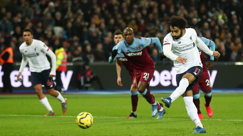 Mohamed Salah scores Liverpool’s first goal from the penalty spot during the Premier League match against West Ham at London Stadium. Photograph: Julian Finney/Getty Images
