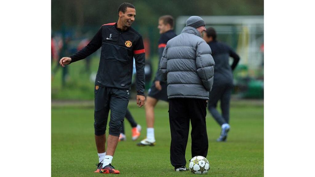 Manchester United manager Alex Ferguson jokes with Rio Ferdinand during a training session at Carrington. Photograph: Richard Heathcote/Getty Images
