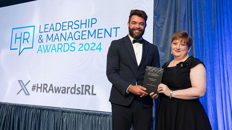 Aricio Silvestre, awards judge, presents the best public sector HR initiative award to Yvonne White, Department of Transport