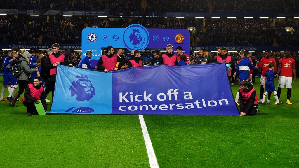Chelsea and Manchester United players pose with a ‘Heads Up’ campaign banner at Stamford Bridge. Photograph: Getty Images