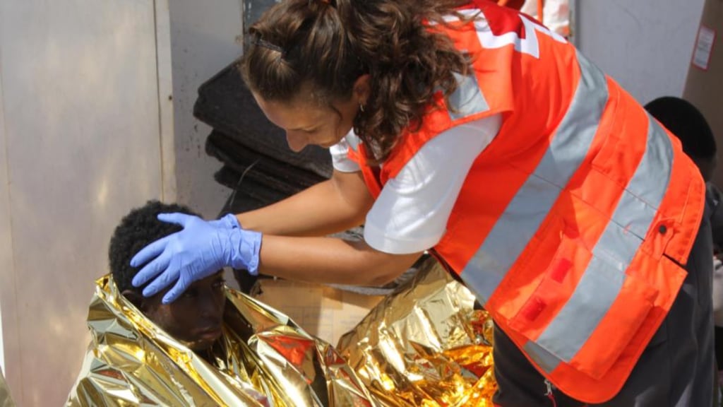 A Red Cross worker with an African migrant after his arrival by sea in Ceuta. Photograph: The Red Cross