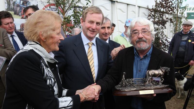 Seán McConnell receiving a lifetime achievement award from Taoiseach Enda Kenny and National Ploughing Association managing director Anna May McHugh at the National Ploughing Championships in 2011. Photograph: Jack Caffrey