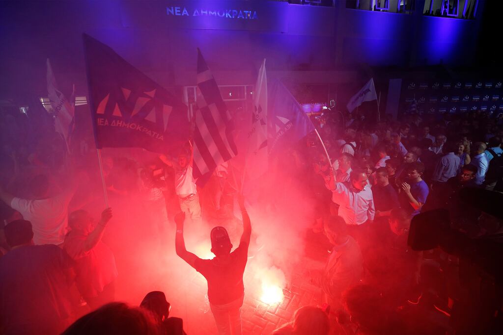 Supporters of the New Democracy party celebrate following the announcement of the results in the Greek general elections outside the party's headquarters in Athens. Photograph: Alexandros Vlachos/EPA