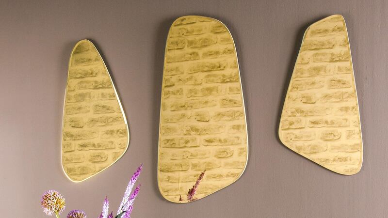 Harvey Norman’s trio of gold mirrors.