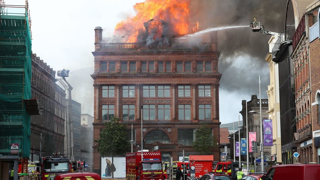 A firefighter trains a hose on a major blaze which has broken out at the Primark store in Belfast city centre. Photograph: Liam McBurney/PA Wire