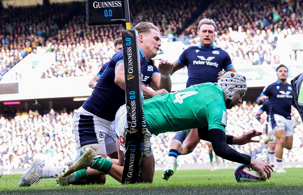 Ireland’s Mack Hansen scores their first try despite the tackle from Duhan van der Merwe of Scotland. Photograph: Billy Stickland/Inpho