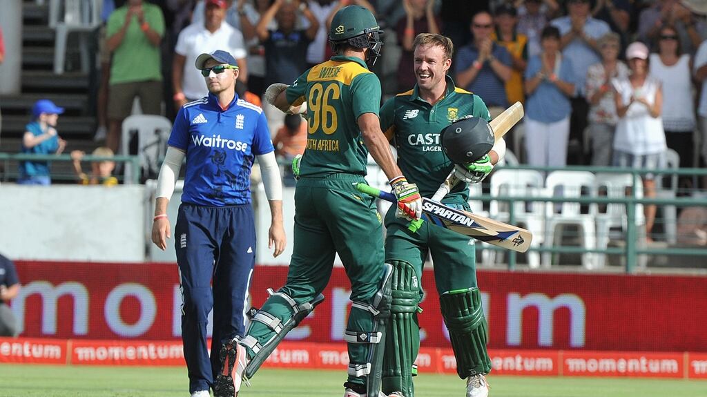 South African batsman David Wiese congratulates AB de VIlliers on reaching his century against England in Cape Town. Photograph: Rodger Bosch/AFP/Getty Images