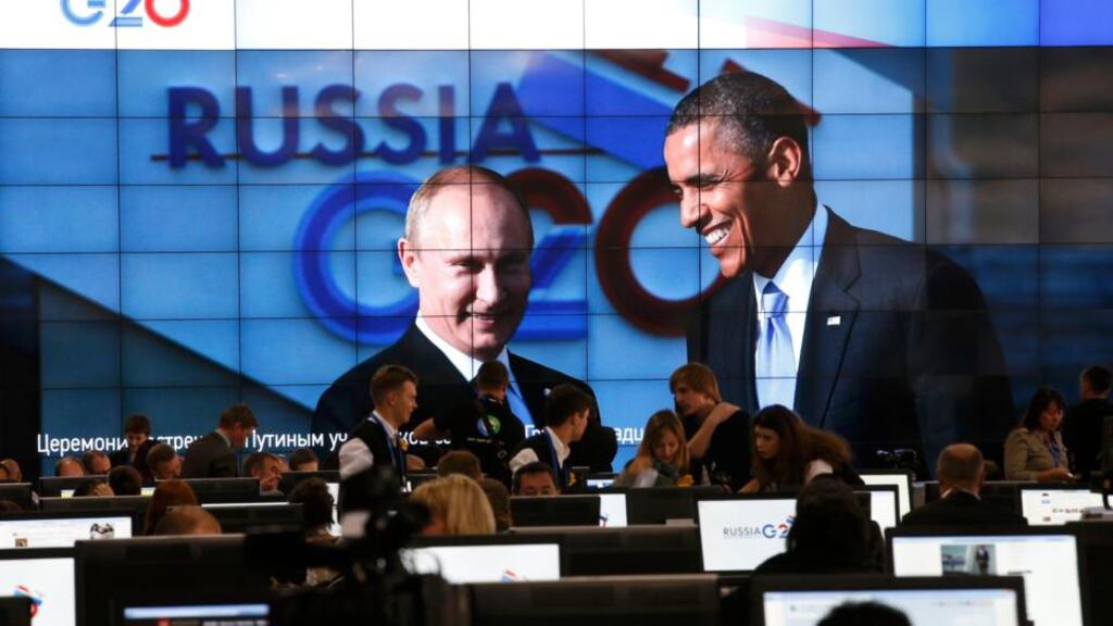 Russian president Vladimir Putin and US president Barack Obama pictured on a video screen installed in the press centre of the G20 Summit in Strelna near St Petersburg yesterday. Photograph: Grigory Dukor/Reuters