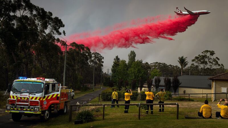 An aircraft drops fire retardant in Hill Top, New South Wales as one of the worst early fire seasons in Australia’s history consumed millions of acres. Photograph: Matthew Abbott/The New York Times.