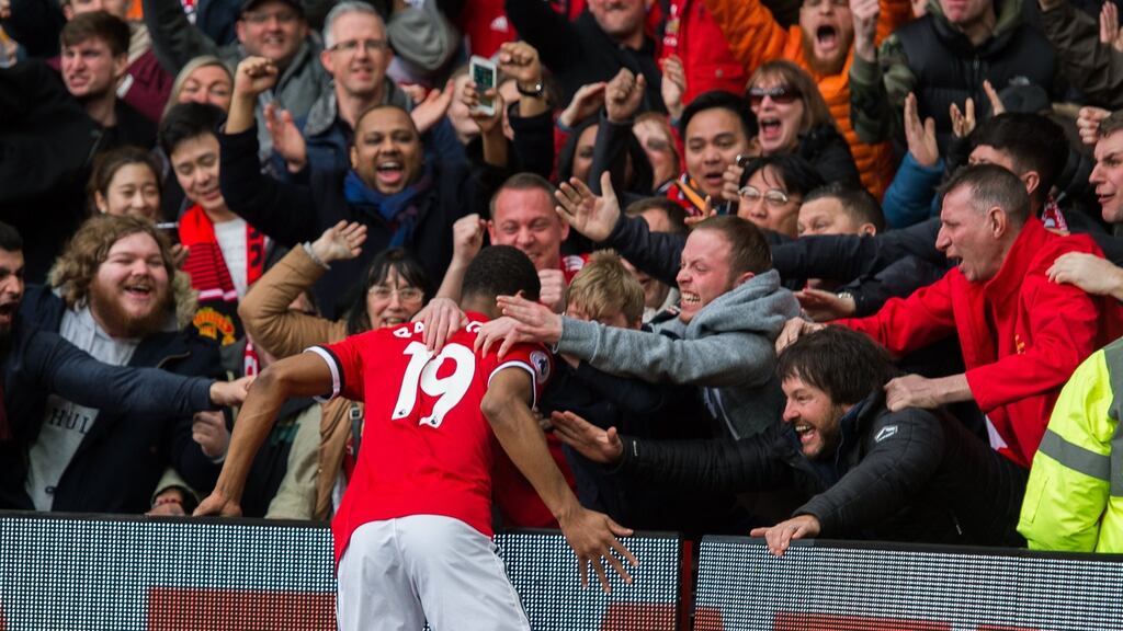 Marcus Rashford celebrates his first goal with the Manchester United fans. Photograph: