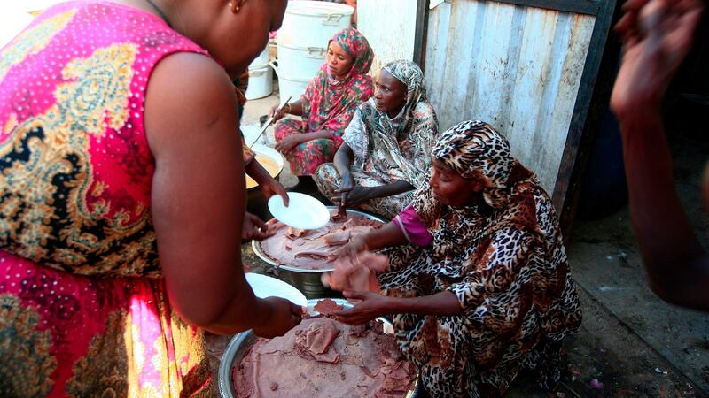 Ethiopian migrants who fled intense fighting in their homeland of Tigray, distribute food to fellow refugees at the border reception centre of Hamdiyet, in the eastern Sudanese state of Kasala, on Saturday. Photograph: Ebrahim Hamid/AFP via Getty Images