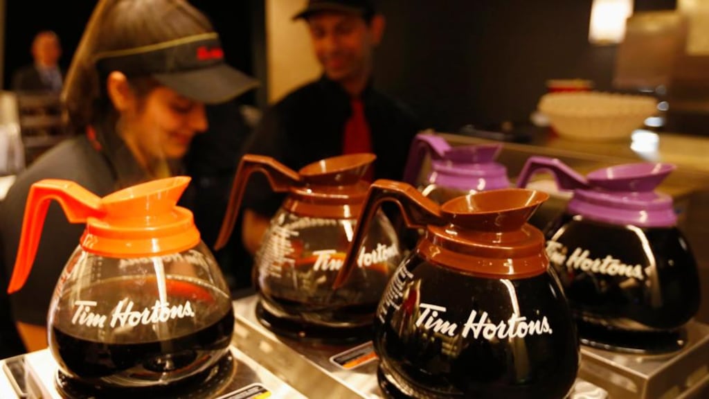 Tim Hortons employees prepare coffee before the company’s annual general meeting in Toronto. Burger King Worldwide is in talks to acquire Tim Hortons. The combined company would be headquartered in Canada, where Tim Hortons is based and taxes are generally lower than in the US. Photograph: Peter Jones/Reuters