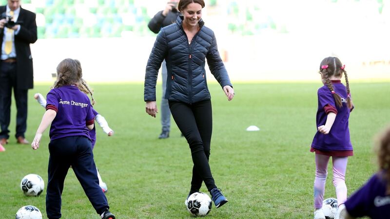 Catherine, Duchess of Cambridge plays some football with young girls as she visits Windsor Park Stadium in Belfast on Wednesday. Photograph:  Jeff J Mitchell/Getty Images