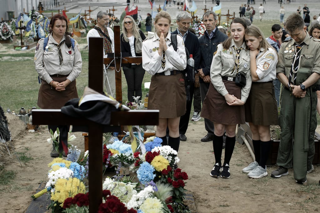 Mourners grieve during the funeral for fallen soldier Artemiy Dymyd at Lychakiv cemetery in Lviv, Ukraine on June 21st, 2022. Photograph: Emile Ducke/New York Times