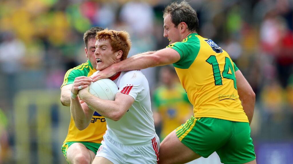 Tyrone’s Peter Harte tackled by  Michael Murphy of Donegal. Photograph: James Crombie/Inpho