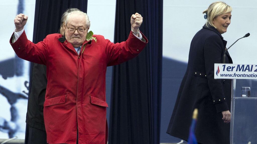 France’s far-right Front National founder and honorary president Jean-Marie Le Pen gesturing on stage with his daughter, Marine, with whom he is at logger heads. Photograph: Kenzo Tribouillard/AFP/Getty