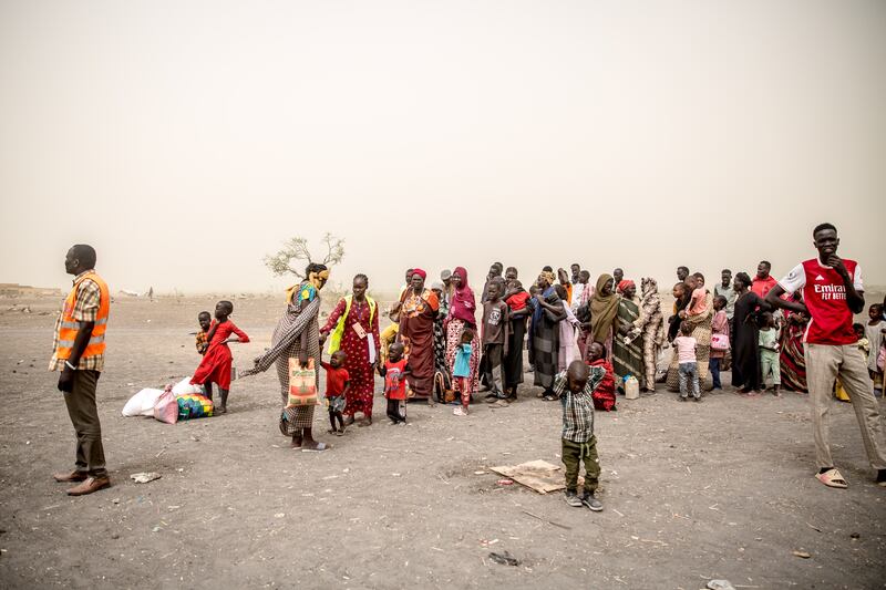 People who have fled Sudan's war line up close to the South Sudan border. Photograph: Sally Hayden