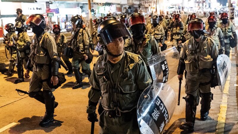 Riot police charge on a street during a demonstration in Yuen Long district on Saturday. Photograph: Anthony Kwan/Getty Images